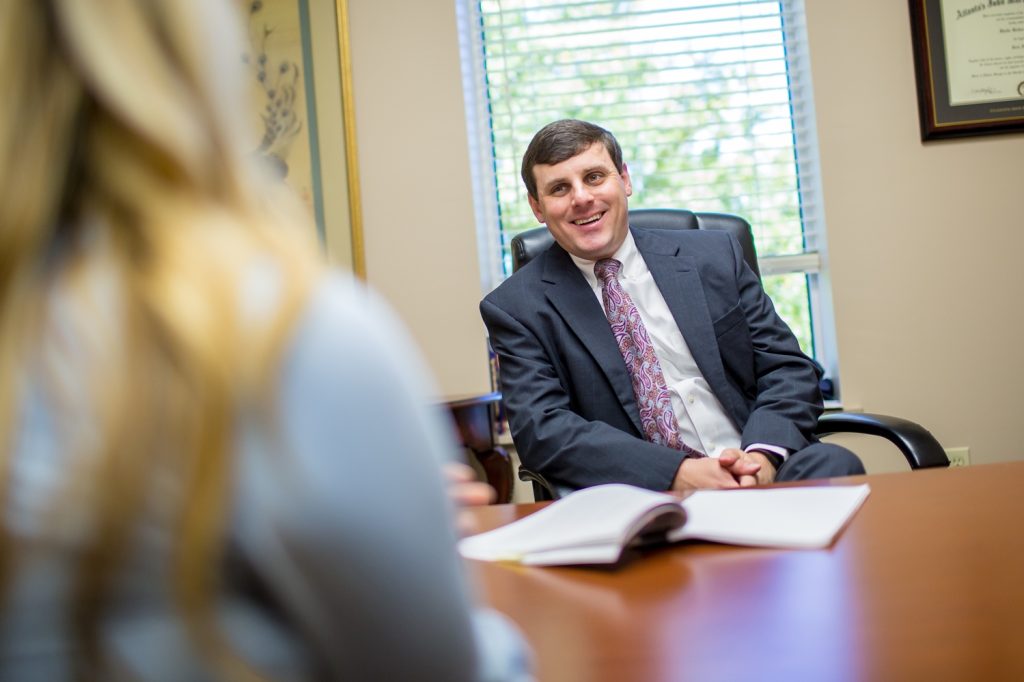 pierce blitch criminal defense attorney with client at desk
