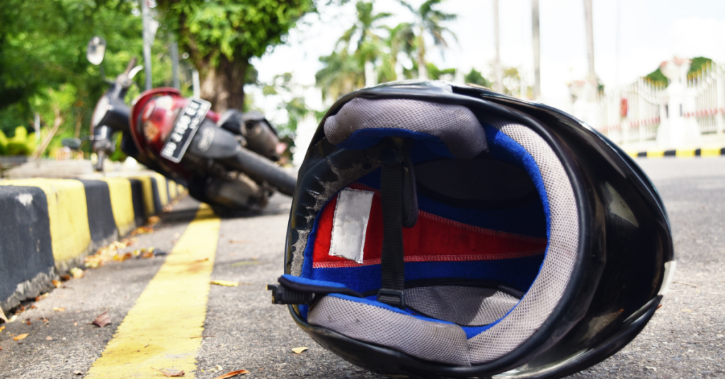 motorcycle accident helmet and bike on the side of the road