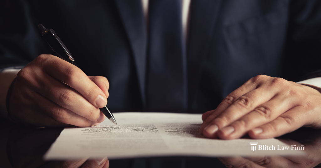 person signing a will during estate planning meeting