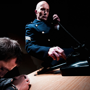 man being detained by police officer